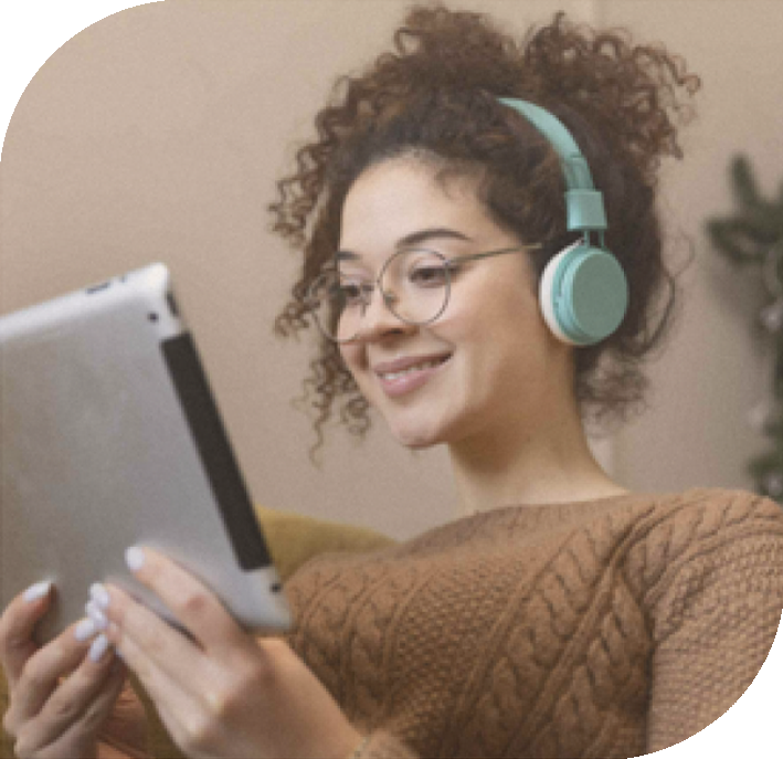 person wearing earphones and looking at a tablet